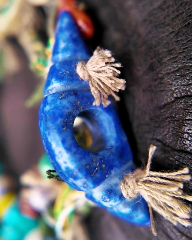 Angled detail of the carved lapis focal and hand-knotted cord in The Gatherer #37