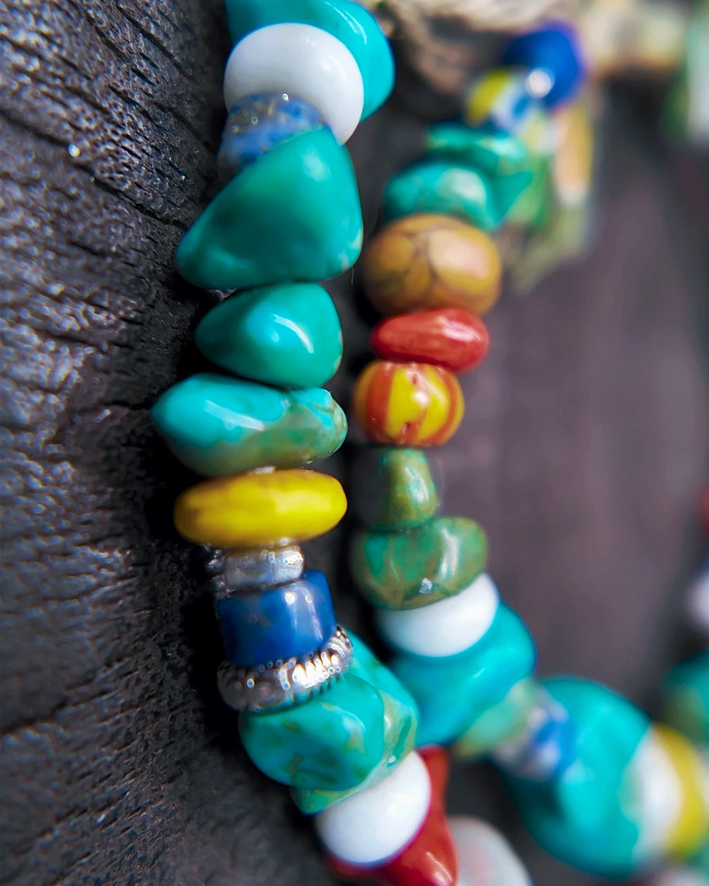 Macro detail of dyed magnesite, lapis, jasper, glass and mother of pearl beads
