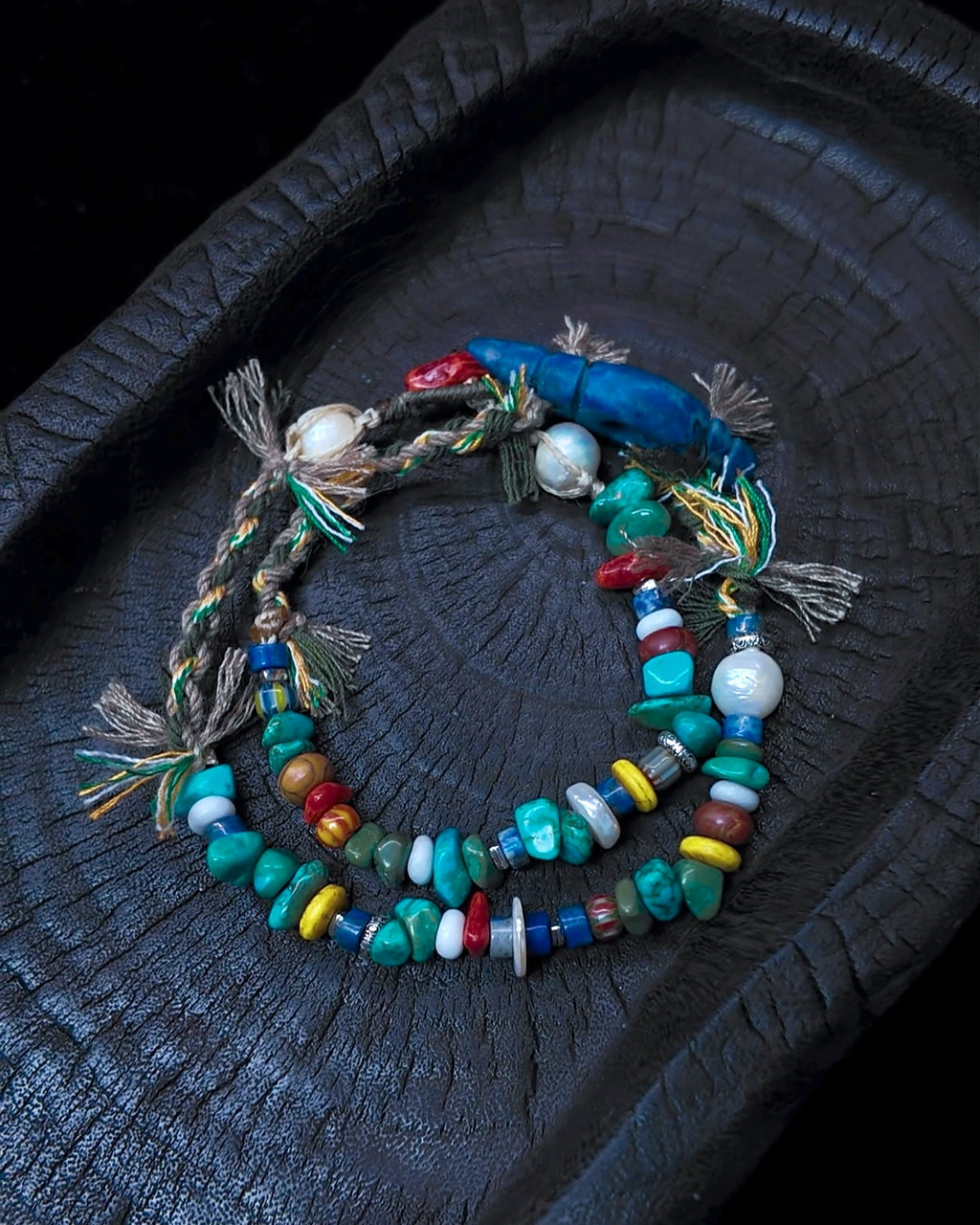 The Gatherer #37 arranged as a wrap bracelet on charred wood
