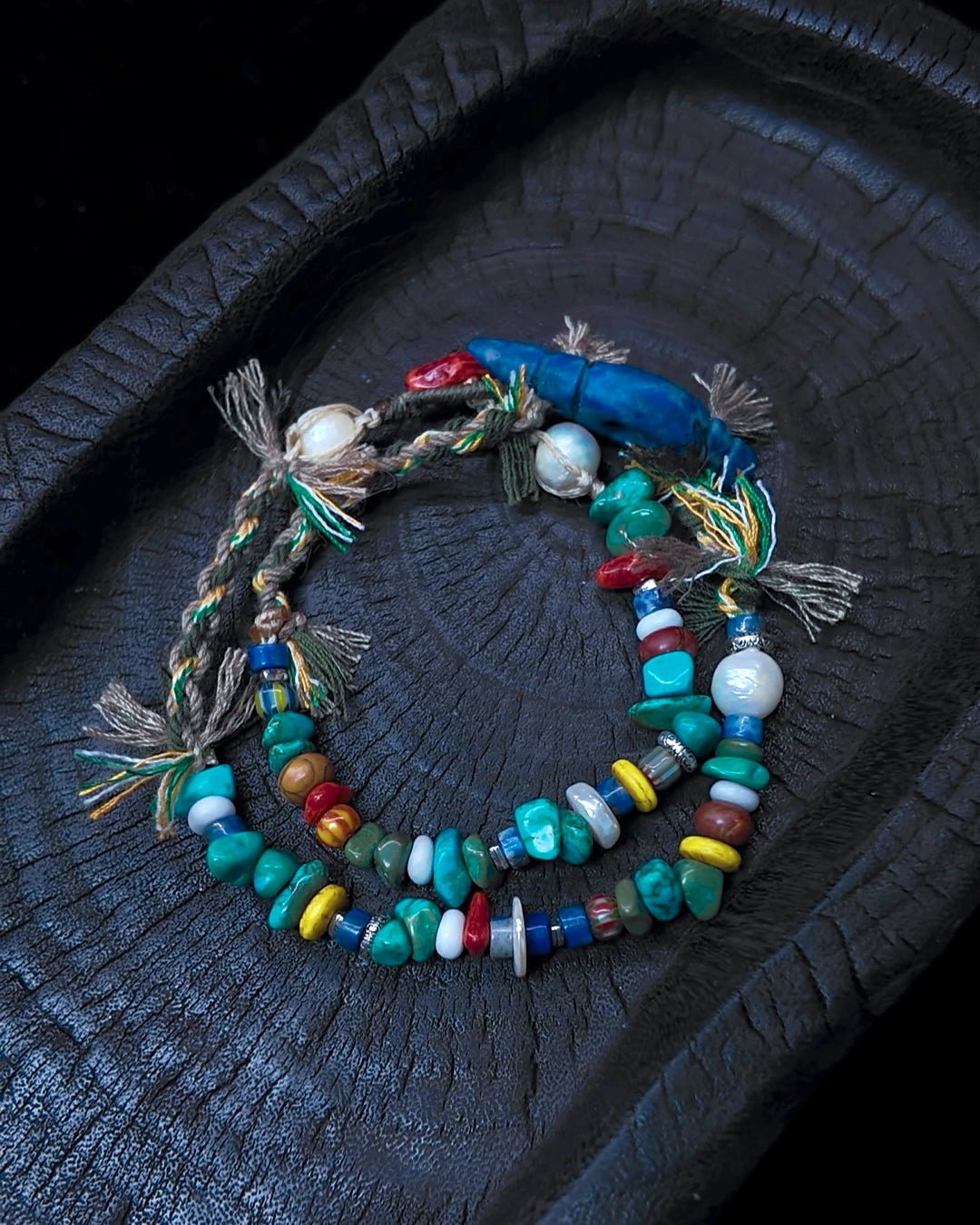 The Gatherer #37 arranged as a wrap bracelet on charred wood