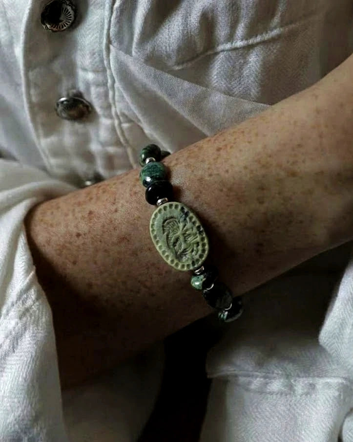 The Greenkeeper #58: Bracelet worn with a pale shirt, showing its green carved focal