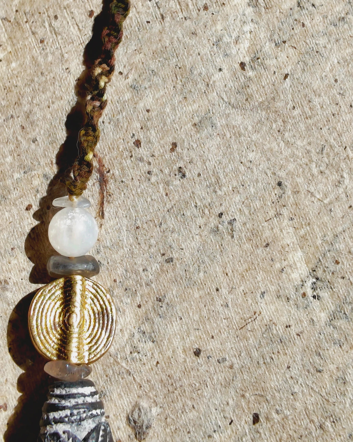 The Inkweave #59: Grooved Nepali brass bead beside pale moonstone and labradorite