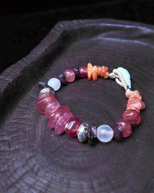The Kindling #34 strawberry quartz garnet moonstone and sunstone bracelet on dark wood