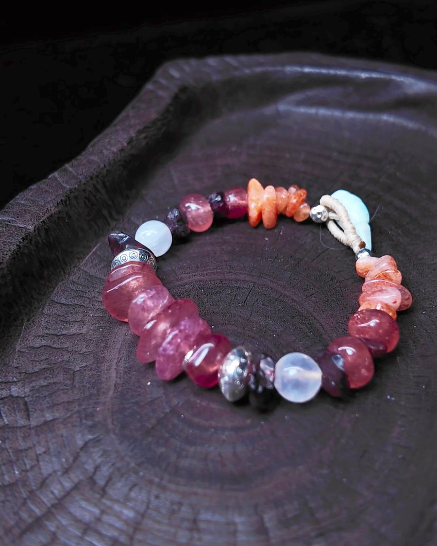 The Kindling #34 strawberry quartz garnet moonstone and sunstone bracelet on dark wood