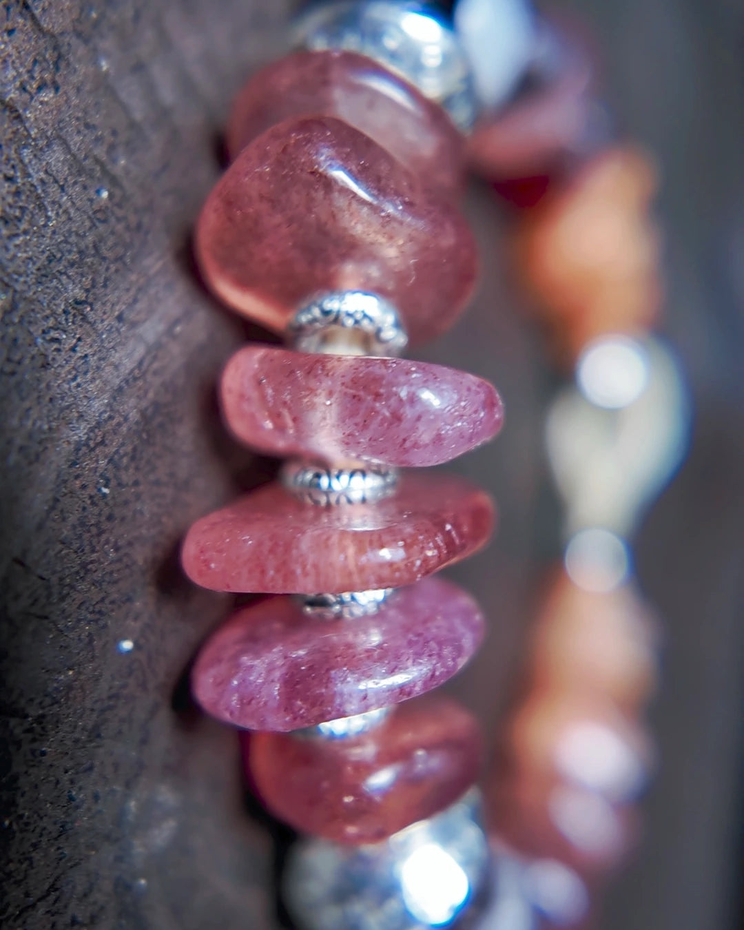 Macro detail of strawberry quartz beads and Tibetan-style antiqued metal spacers