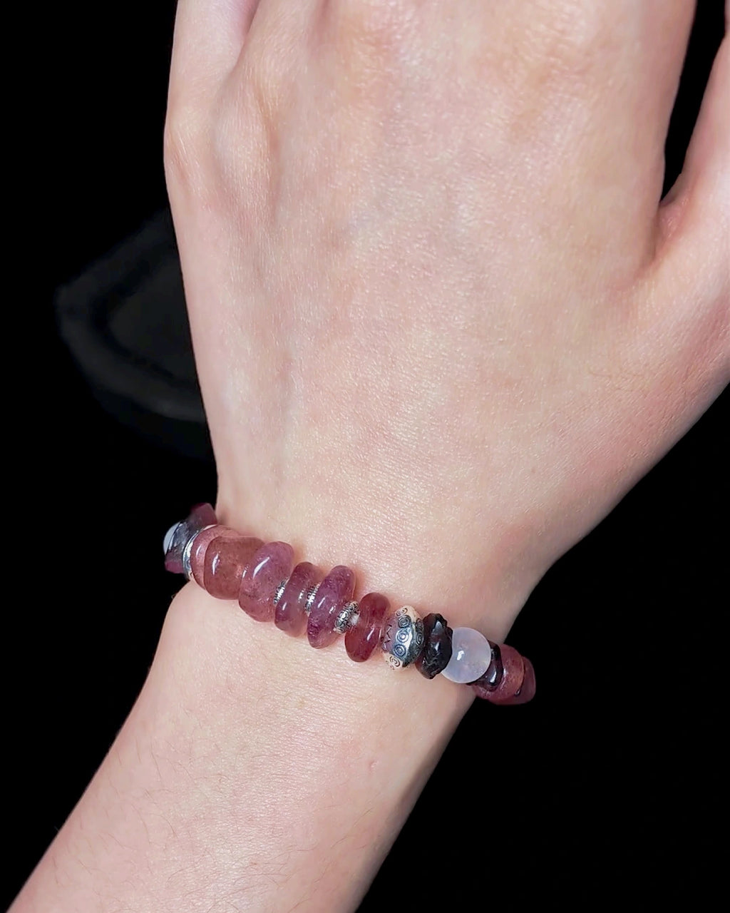 Close wrist fit view of The Kindling #34 strawberry quartz and garnet bracelet