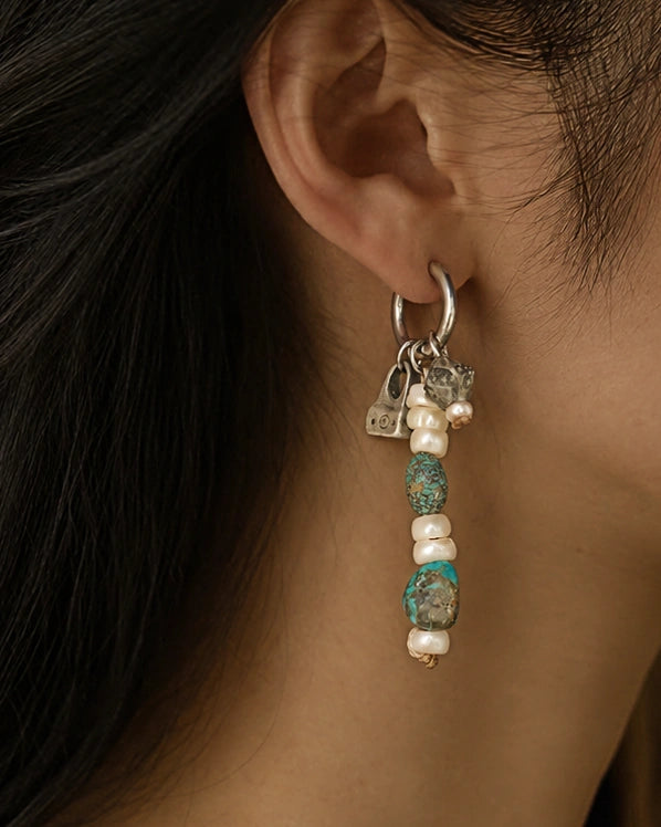 The Littoral #51: Earring worn in profile, showing its drop against the ear and neck