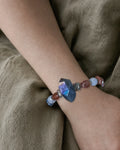 The Lucent #35 exact labradorite, sunstone, and blue moonstone bracelet worn on an editorial model wrist