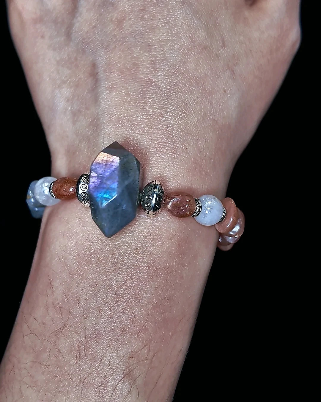 The Lucent #35 labradorite sunstone and blue moonstone bracelet worn on wrist