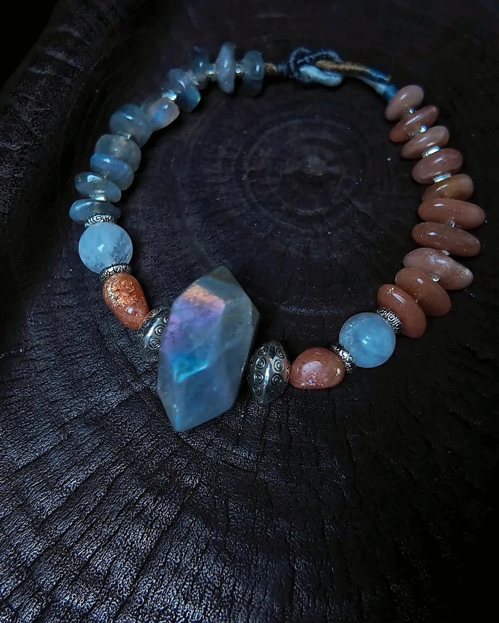 The Lucent #35 full bracelet on dark wood with labradorite focal bead