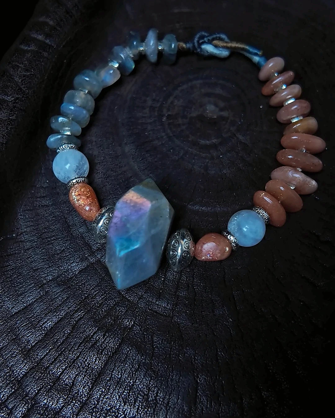 The Lucent #35 full bracelet on dark wood with labradorite focal bead