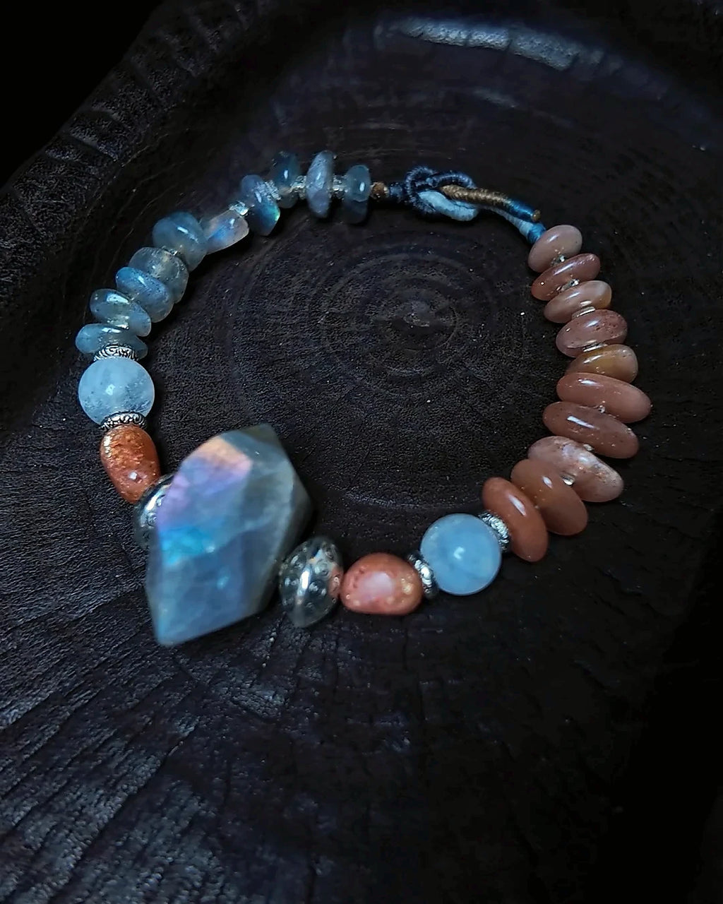 Angled full view of The Lucent #35 labradorite sunstone and moonstone bracelet