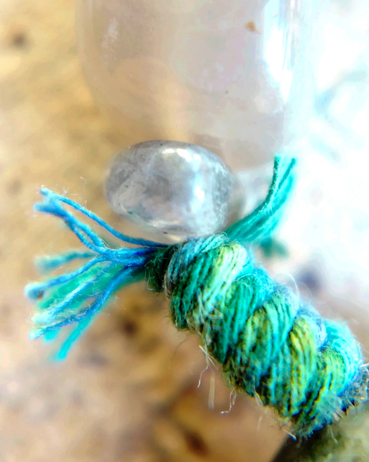 Close view of teal plant-dyed cotton wrapped around the waxed cord