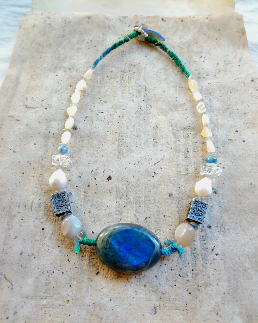 Full view of the fixed 51 cm Moonwake #44 necklace with teal wrapped cord and labradorite finishing stones