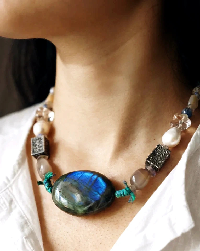 The Moonwake #44 labradorite and pearl necklace worn with an open white shirt for scale